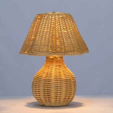 A woven wicker table lamp, lit
